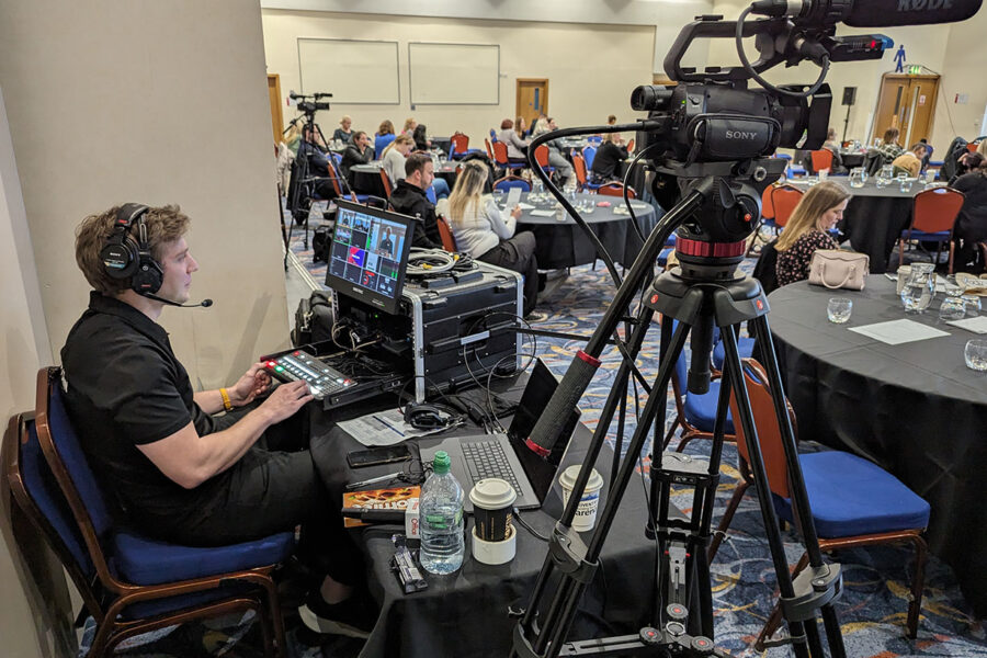 Videographer managing the event recording setup