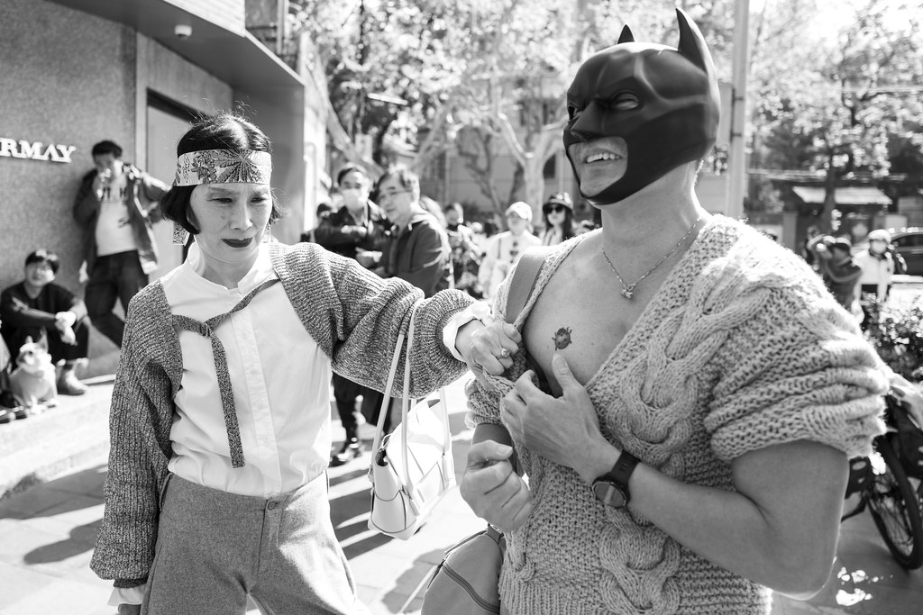 Man in Batman mask in Shanghai showing off his ladybird tattoo