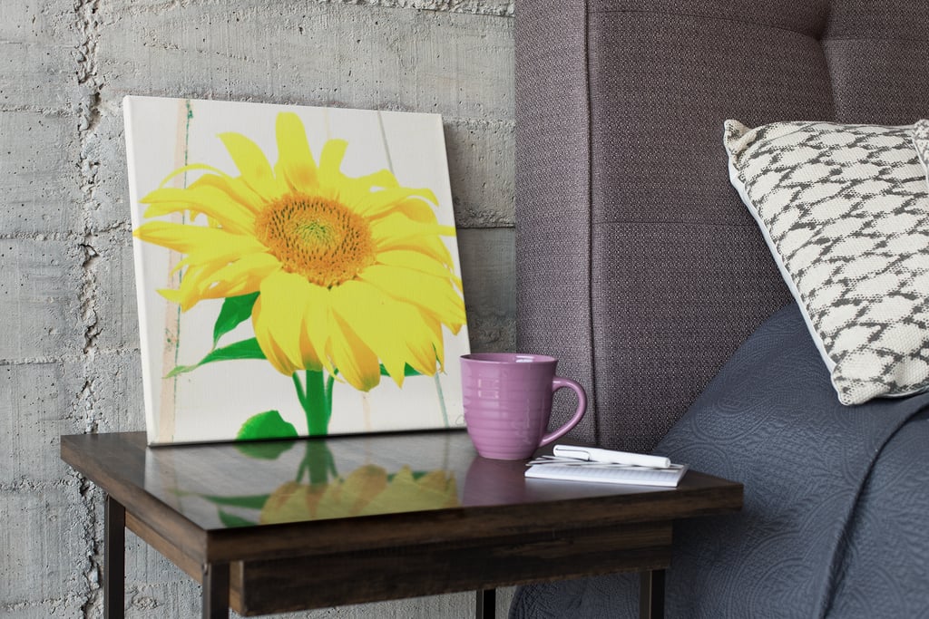 Digital image of a canvas print on a bedside table with an image of an artistic Sunflower on it.