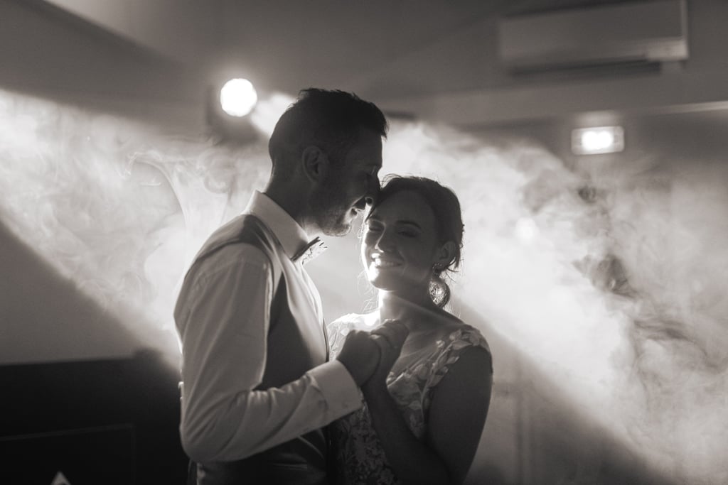 a man and woman standing in front of a smoke filled room