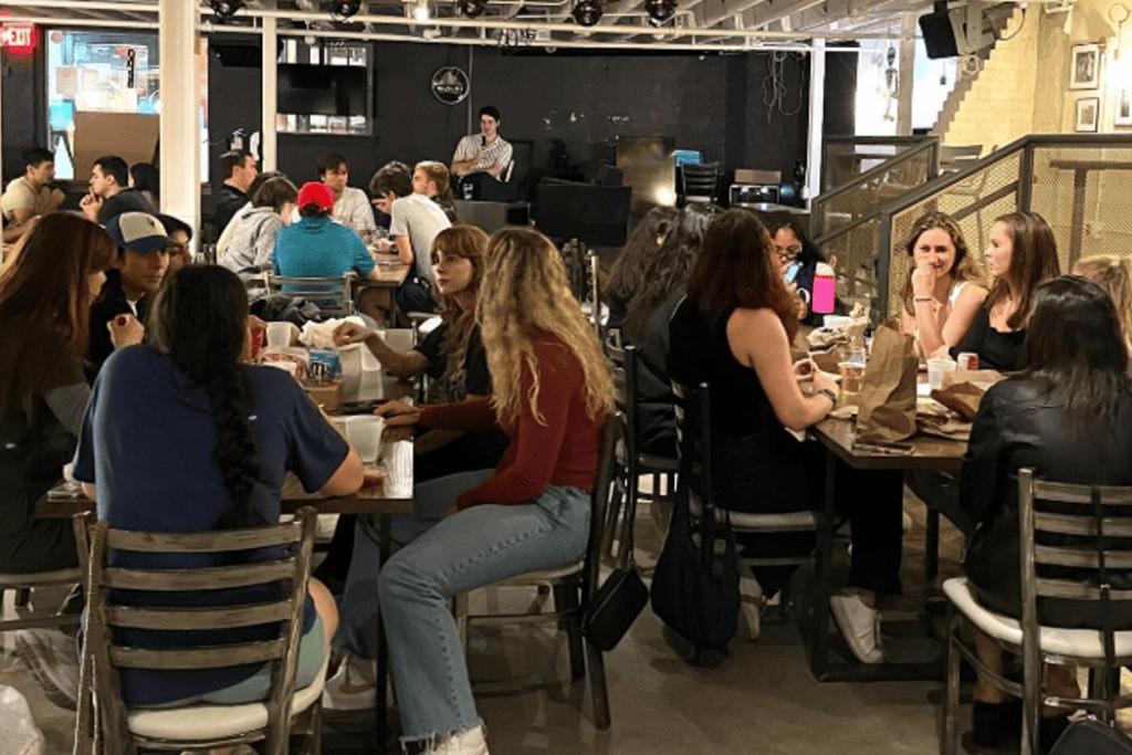 a group of people sitting at a table with drinks