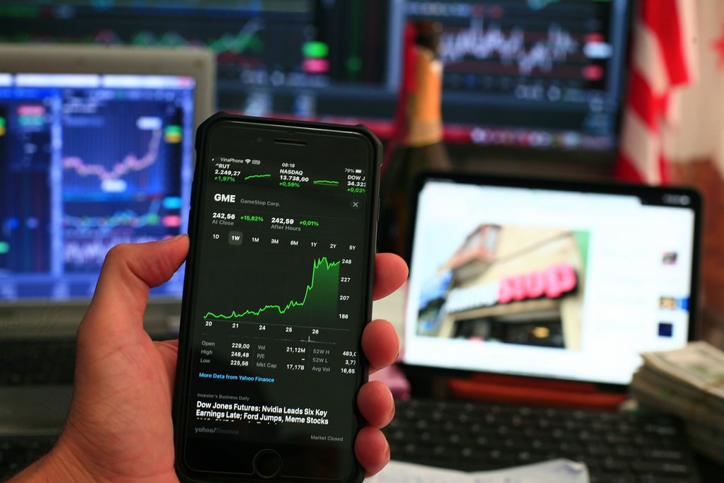 phone showing investing chart symbolizing market volatility