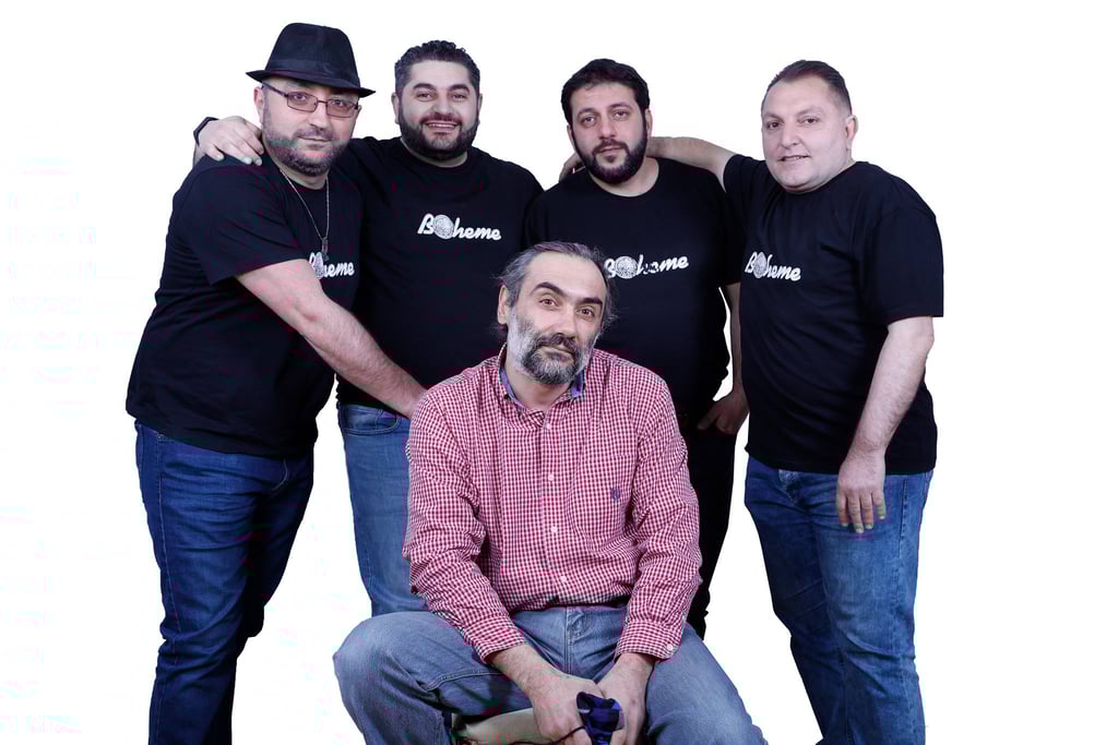 Five men wearing Boheme t-shirts and casual jeans posing together against a white background.