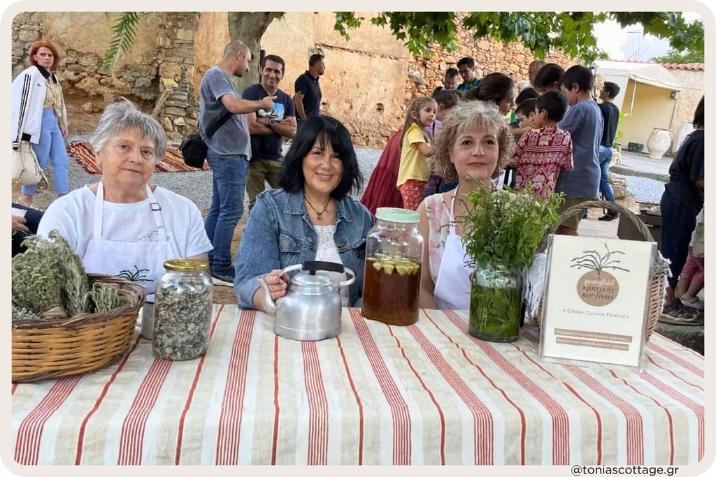 Three women at an outdoor stall at the Cretan Cuisine Festival.