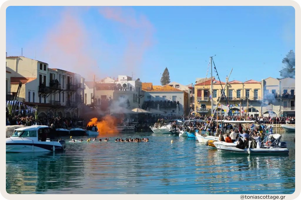 Epiphany celebration in a Cretan harbor with crowds, boats, swimmers, and smoke over the water