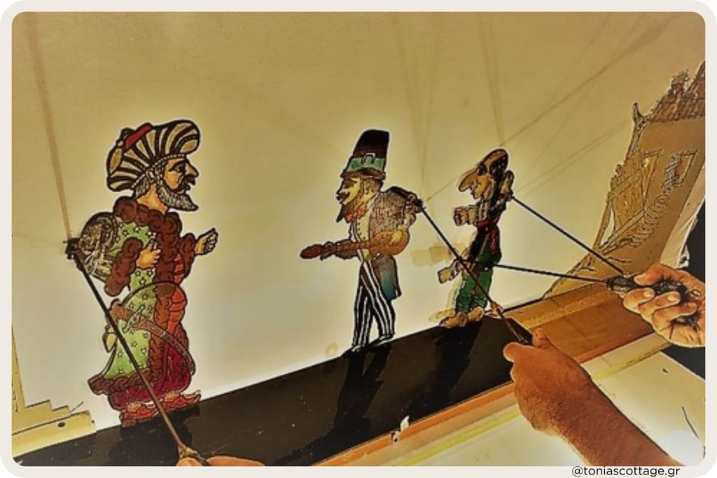 Hand holding strings of traditional shadow puppets performing on a lit stage - Greek Karagiozis