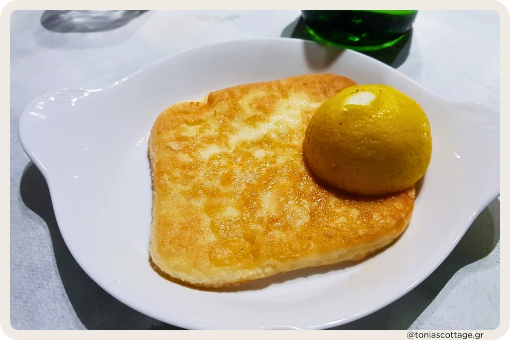 Golden fried saganaki cheese with a lemon wedge