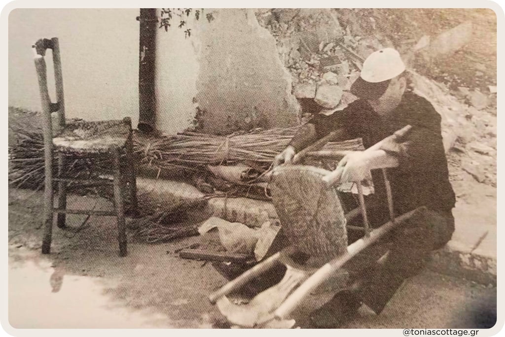 Cretan craftsman weaving a traditional kareklas chair from reeds outdoors