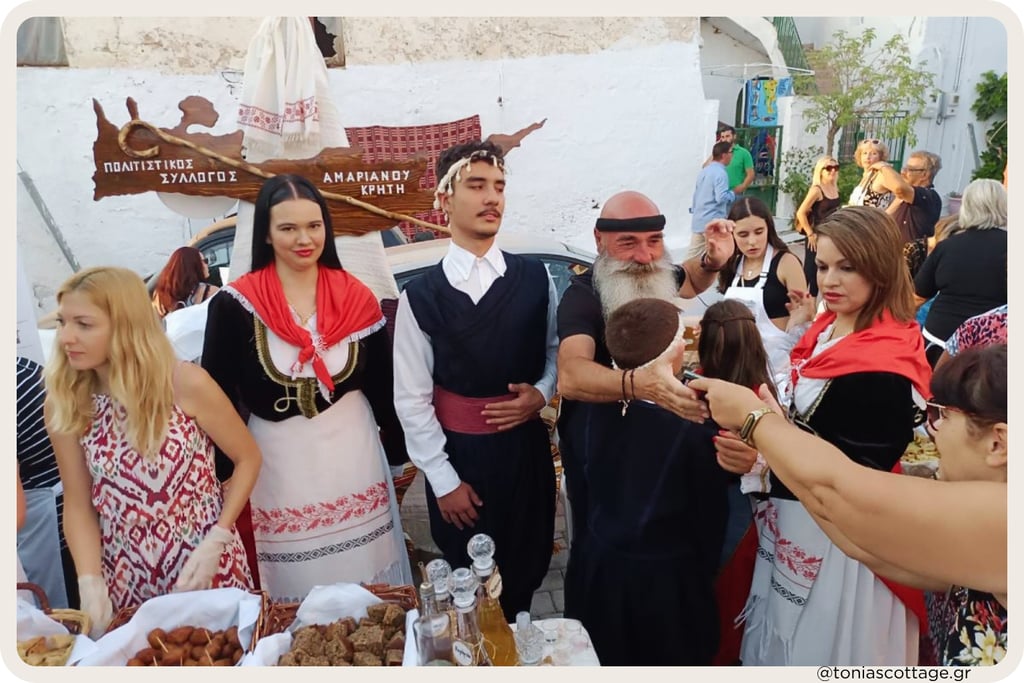 Participants in traditional Cretan costumes at an outdoor event at the Cretan Cuisine Festival.