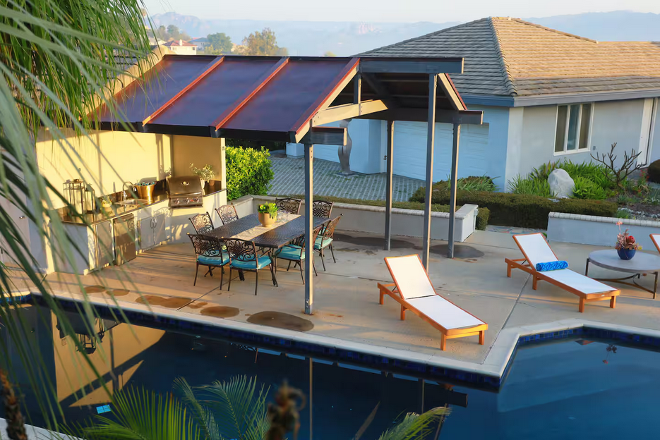 a pool with lounge chairs and a patio table