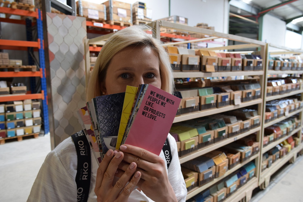 a woman holding a book in a store