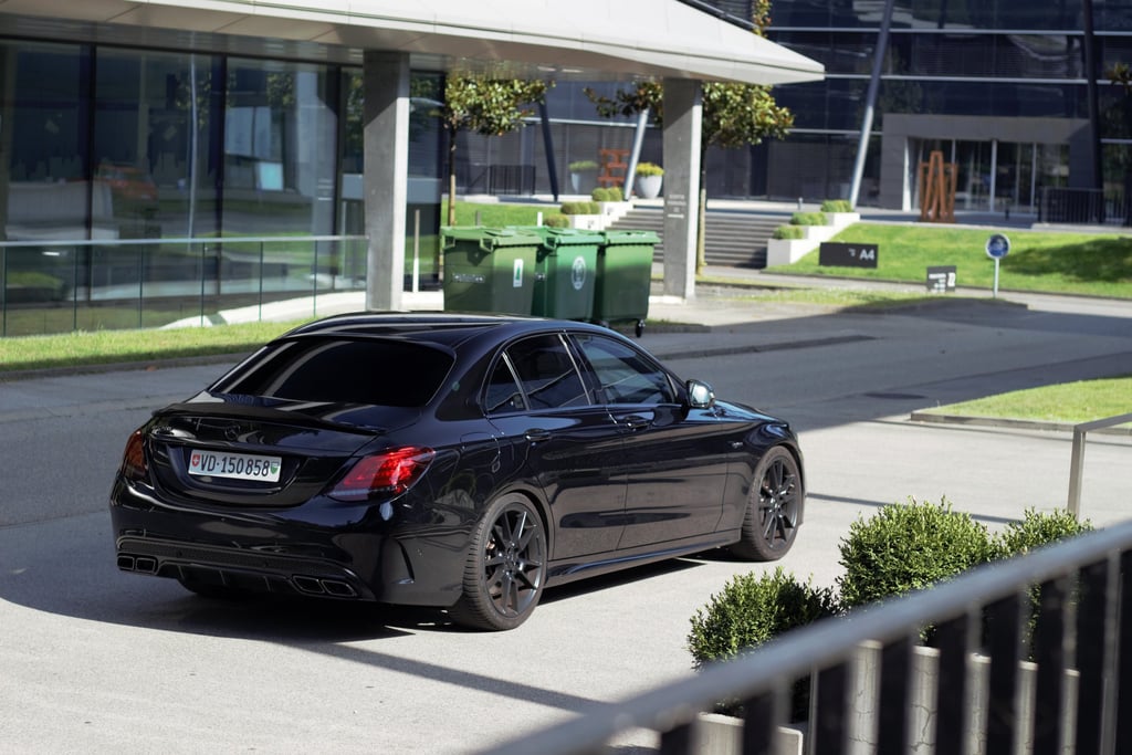 a black car parked on a street corner
