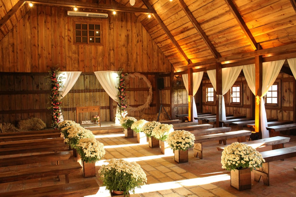 a barn decorated in off whites for a wedding