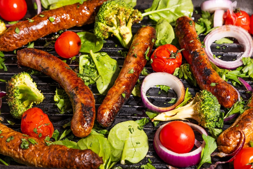 Sustainable plant-based, nutritionally-dense, hypoallergenic protein and fibre sausages with vegetables surrounding