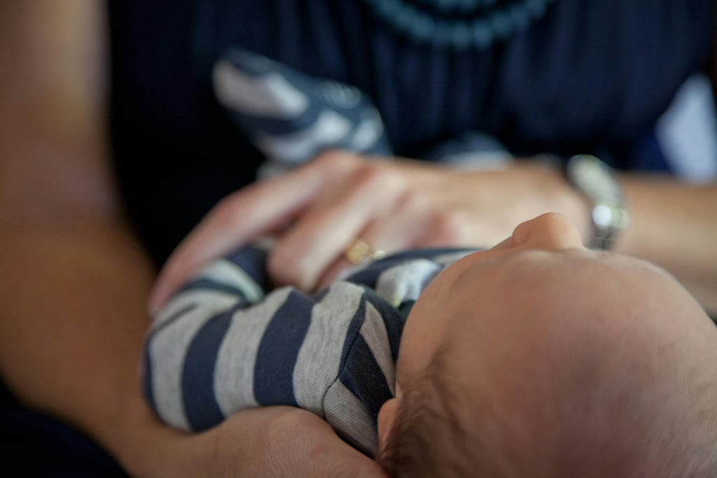 baby held by two hands
