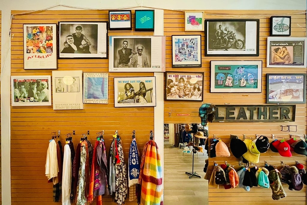 photo from inside Magpie Thrift Capitol Hill showing scarves and hats under framed pride photos