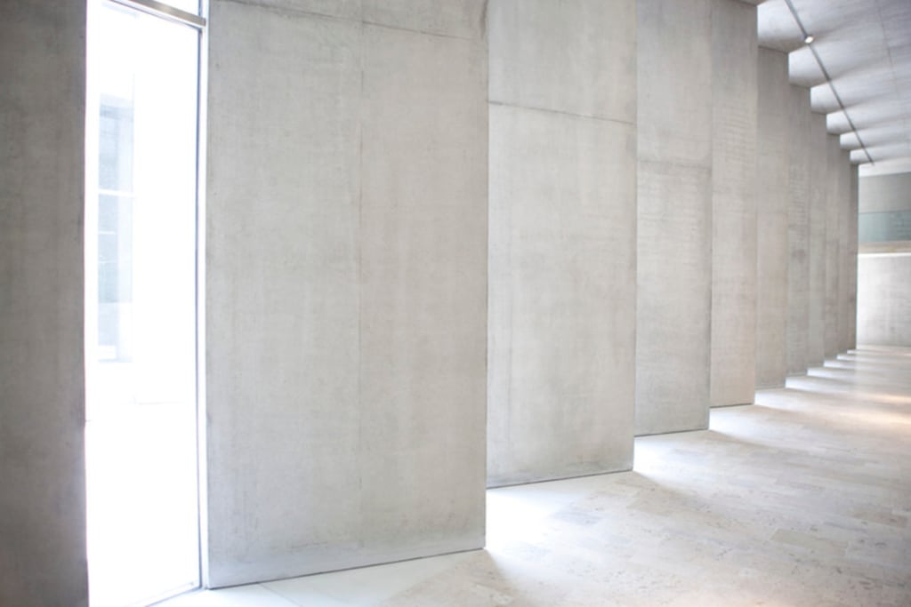 a room with a large window and a wall with a long row of stairs