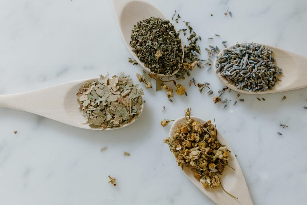 four spoons with various dried herbs
