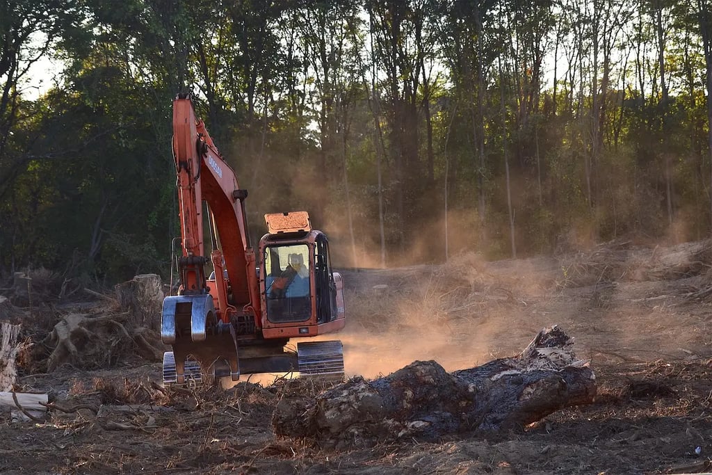 a tractor with a tractor loader in the dirt