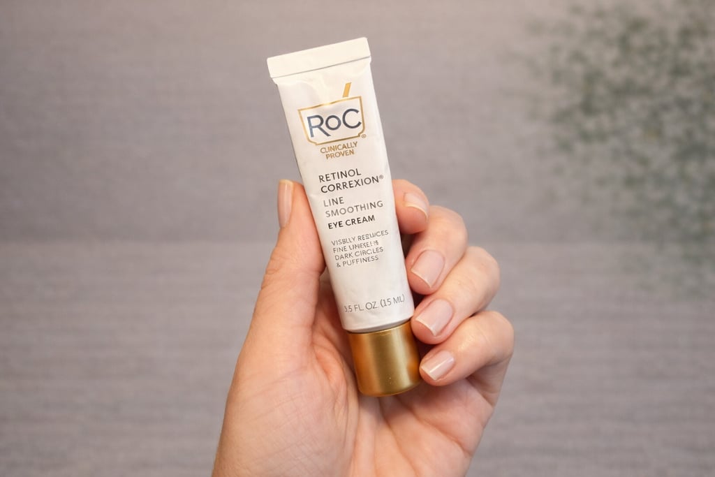 Hand holding RoC Retinol Correxion line smoothing eye cream for fine lines and dark circles