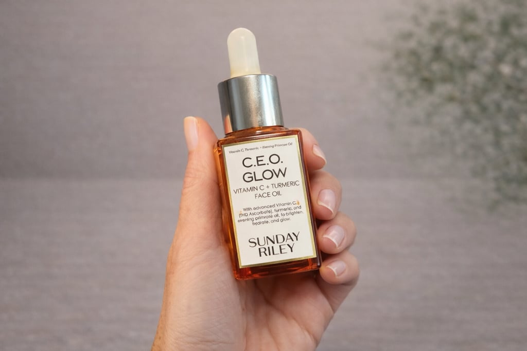Hand holding Sunday Riley C.E.O. Glow vitamin C face oil with turmeric for radiant skin