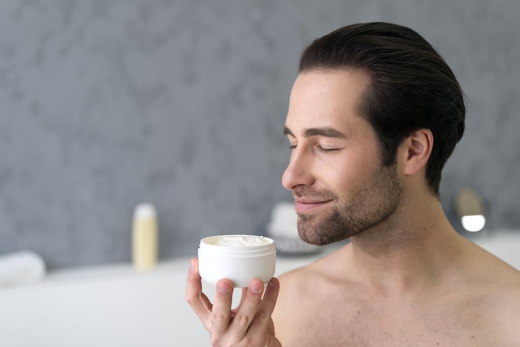 a man applying beard balm