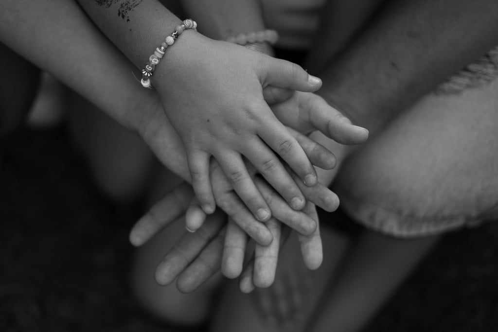 Black and white image with hands holding each other 