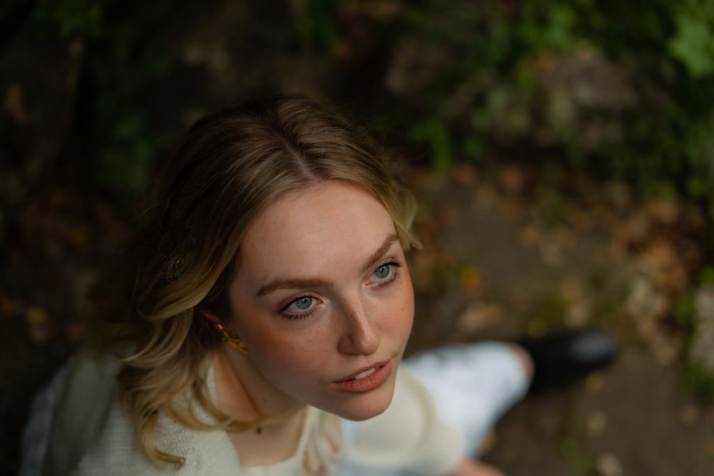 woman sitting in the forest looking up