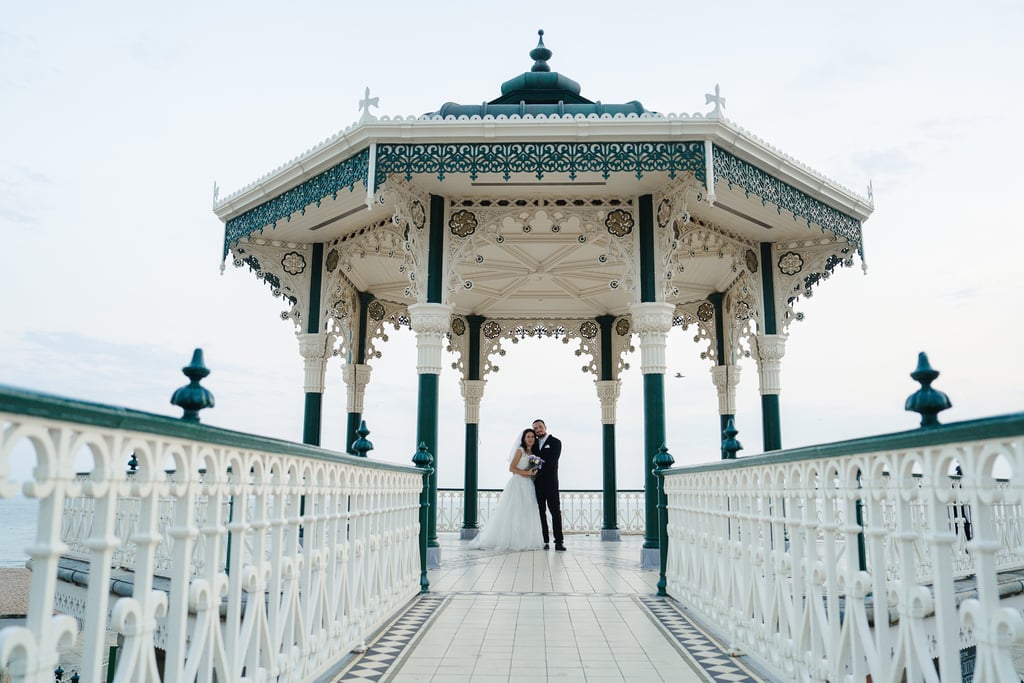 married couple holding hands by the sea
