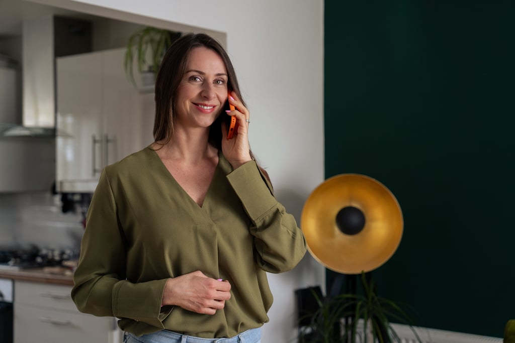 Woman holding a phone and smiling