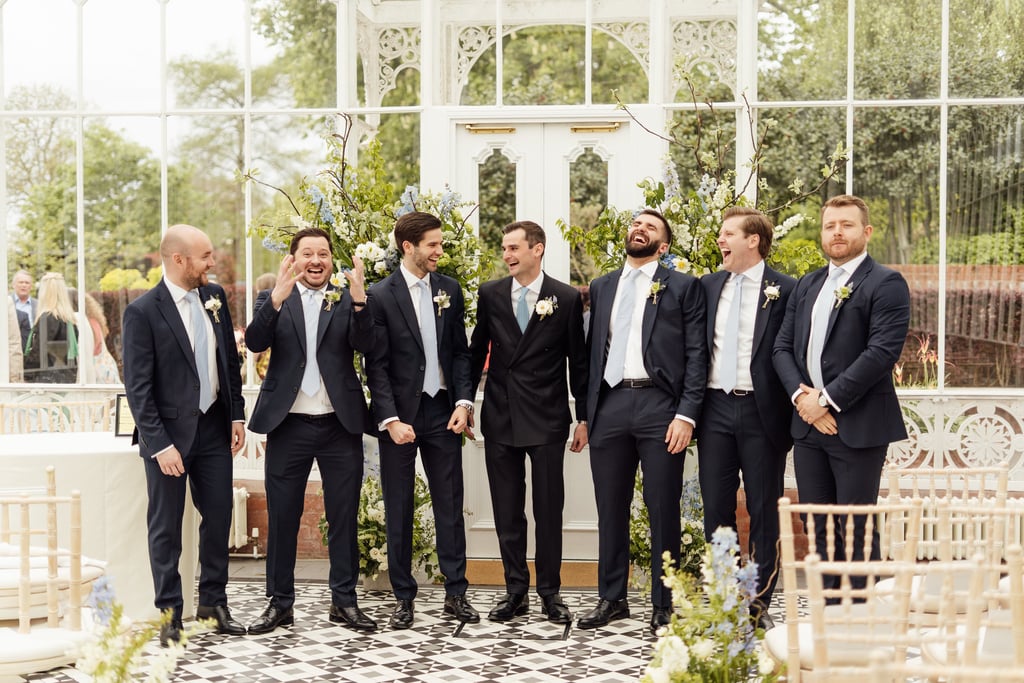 Groom with groomsmen laughing 