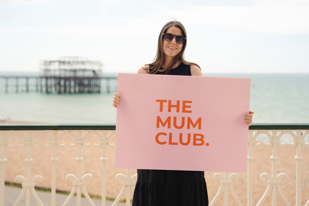 woman holding a sign on the seafront