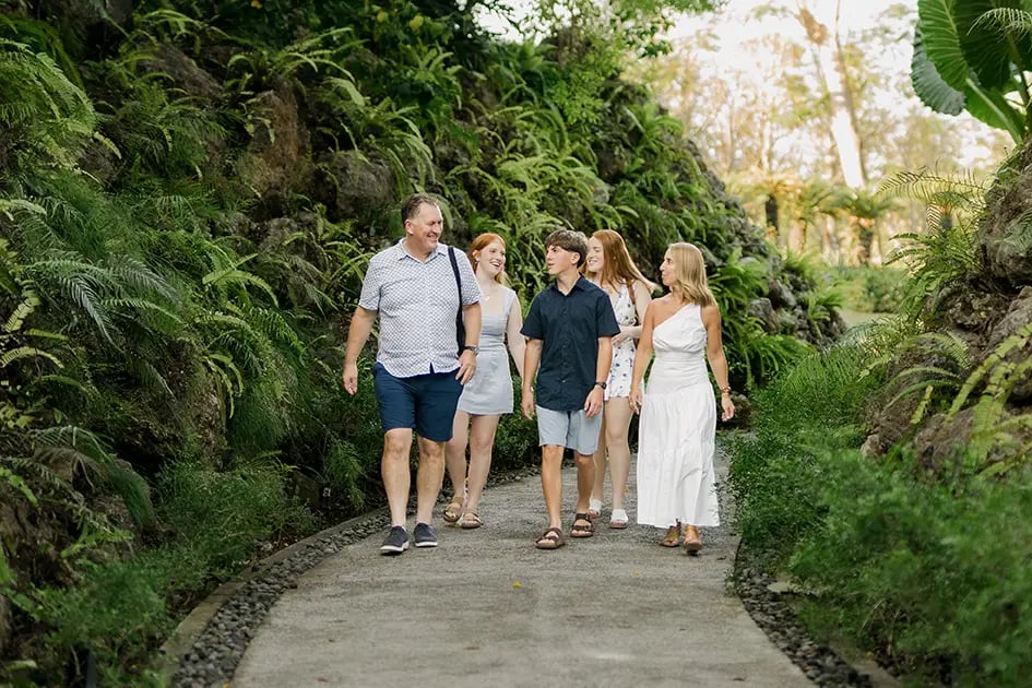 Family walking together through the tropical gardens at AYANA Resort Bali