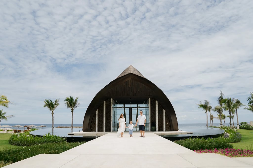 Family portrait at the entrance of the iconic chapel at The Apurva Kempinski Bali