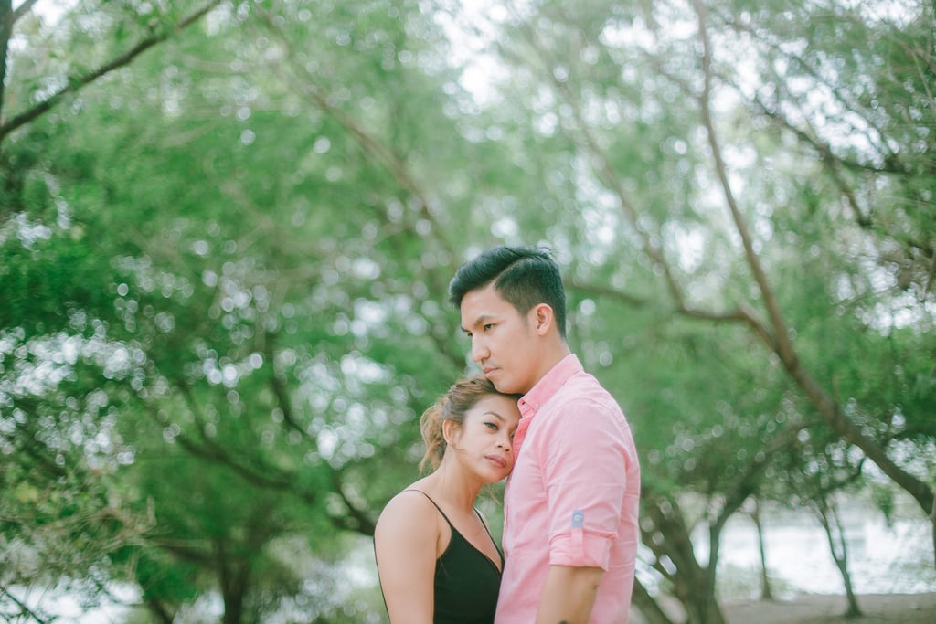 Intimate couple embrace under trees during a photography session in Serangan Benoa Bali.