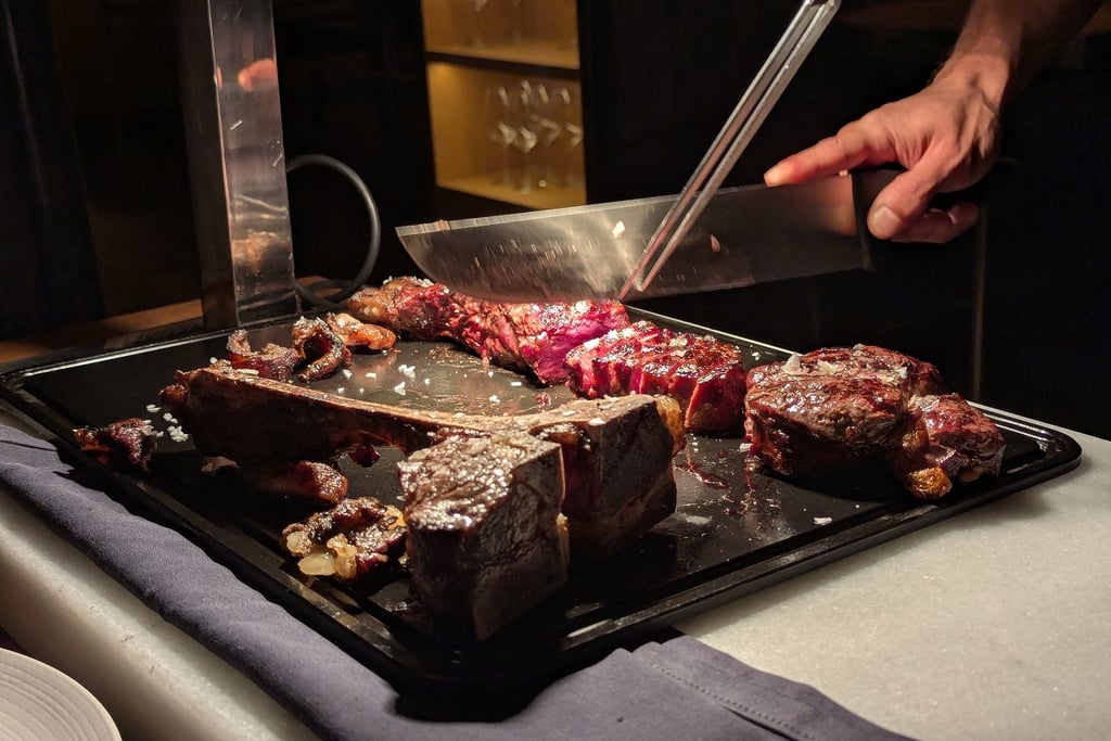 T-bone steak being sliced at the LomoAlto steakhouse in Barcelona
