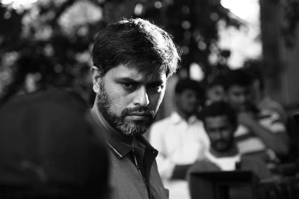 black and white photo of filmmaker himayath khan from the sets of Kannada film Just Aakasmika