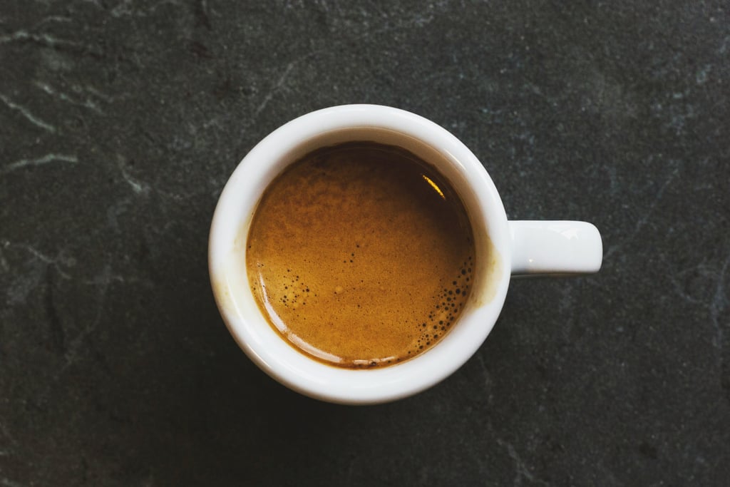 An espresso cup on top of a grey table