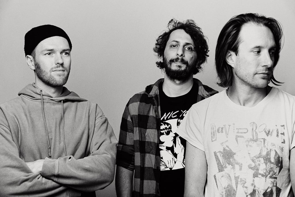 A three piece band black and white portrait.