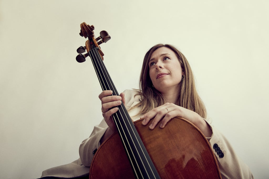 Cello player photographed from below in a photo studio.