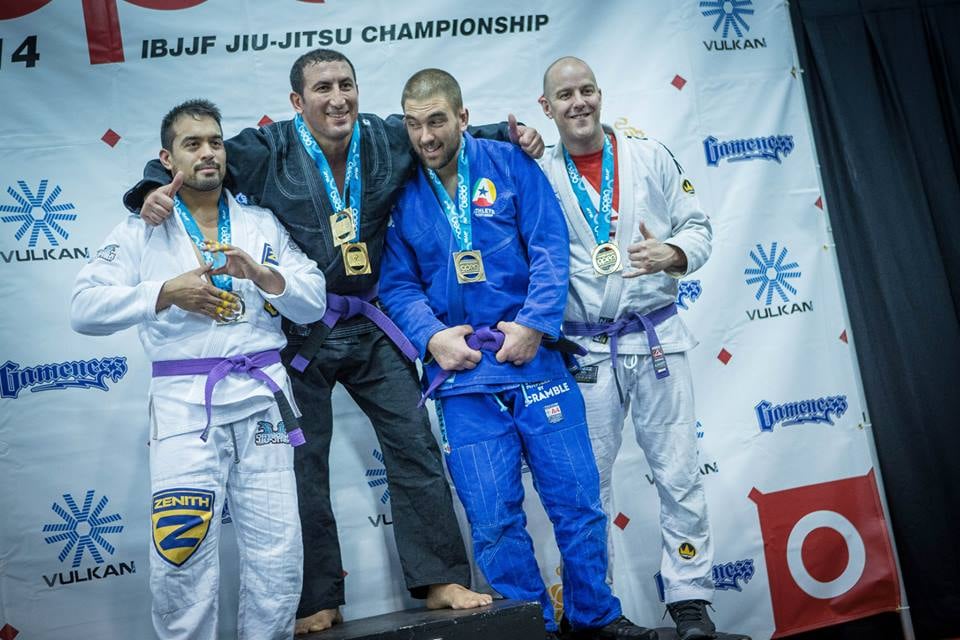 a group of people standing on a stage with medals