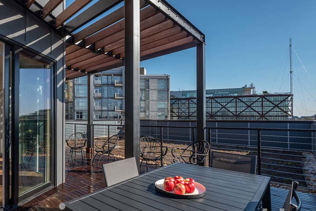 A photo of an exterior trellis over a rooftop deck