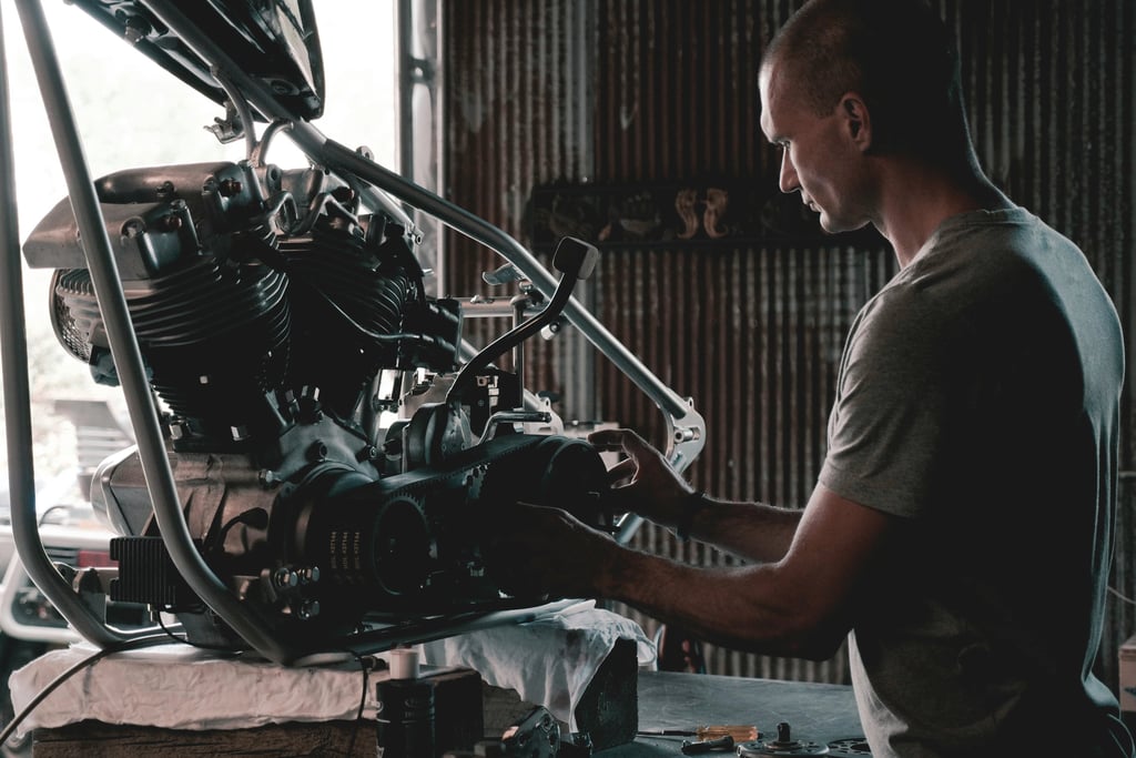 man working on his motorcycle engine