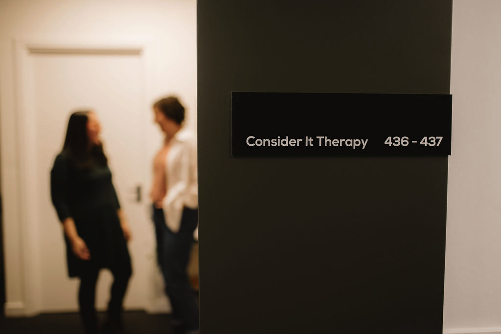 The Consider It Therapy nameplate at Baltic Chambers, with two therapists visible in the background