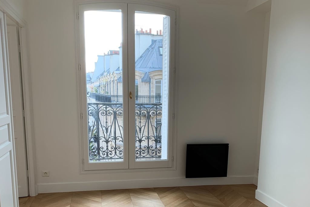 a room with a large window and a television