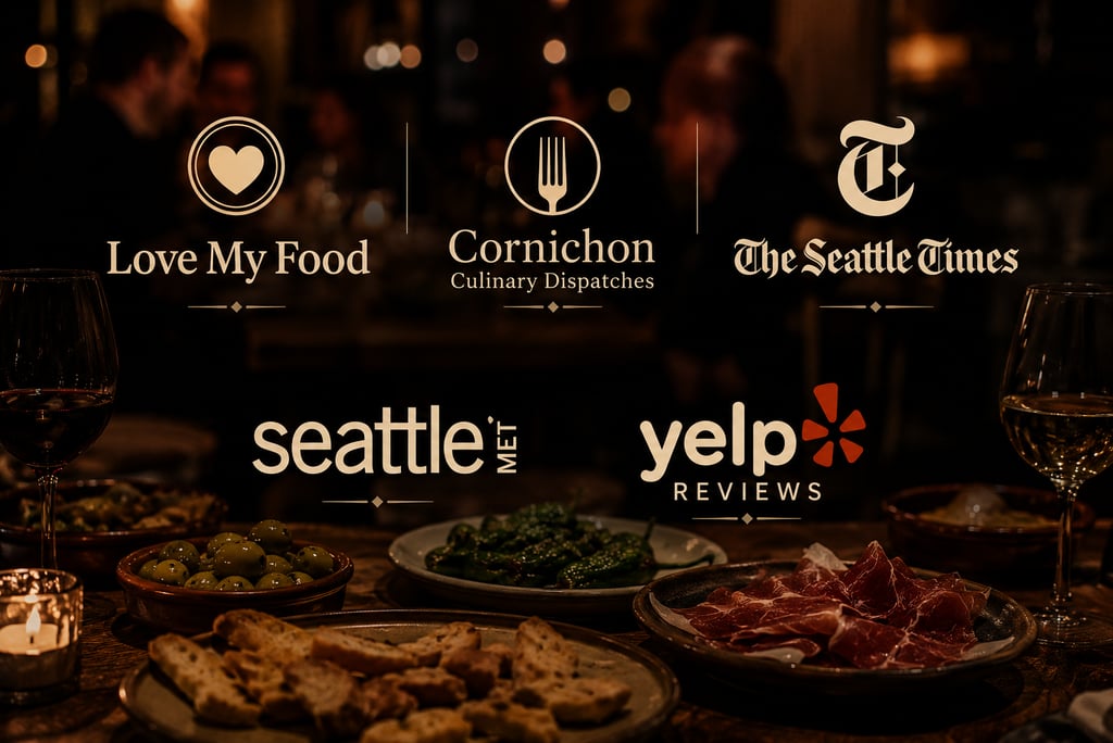 Spanish tapas and wine on a table with press logos from Seattle Met and The Seattle Times.