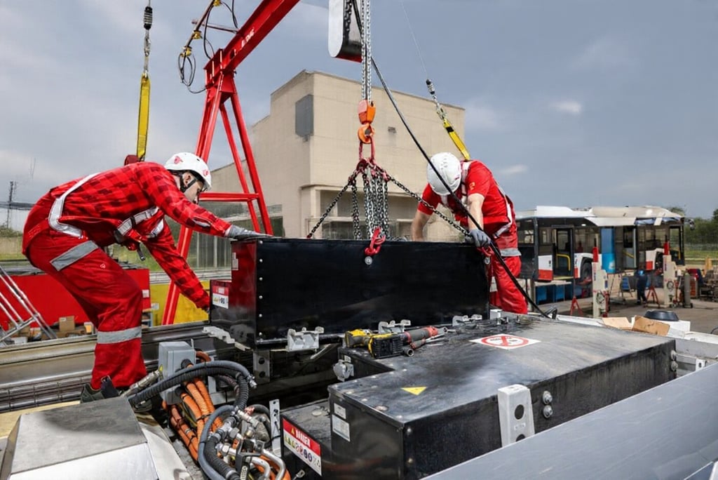 Technicians installing the EV batteries
