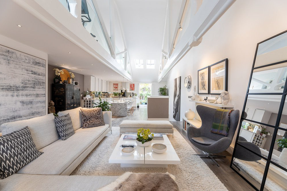 a living room with a couch and a ladder