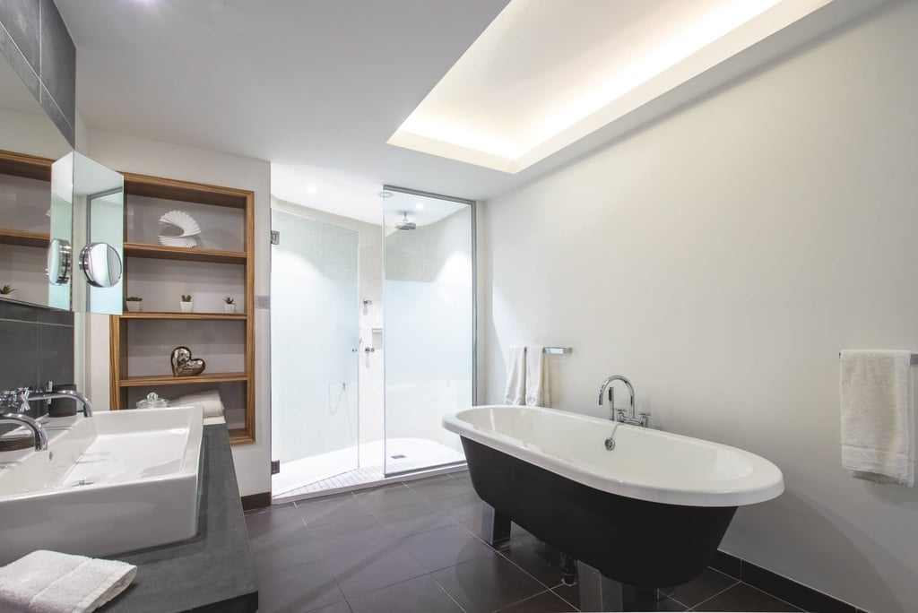 a bathroom with a bathtub and a shower