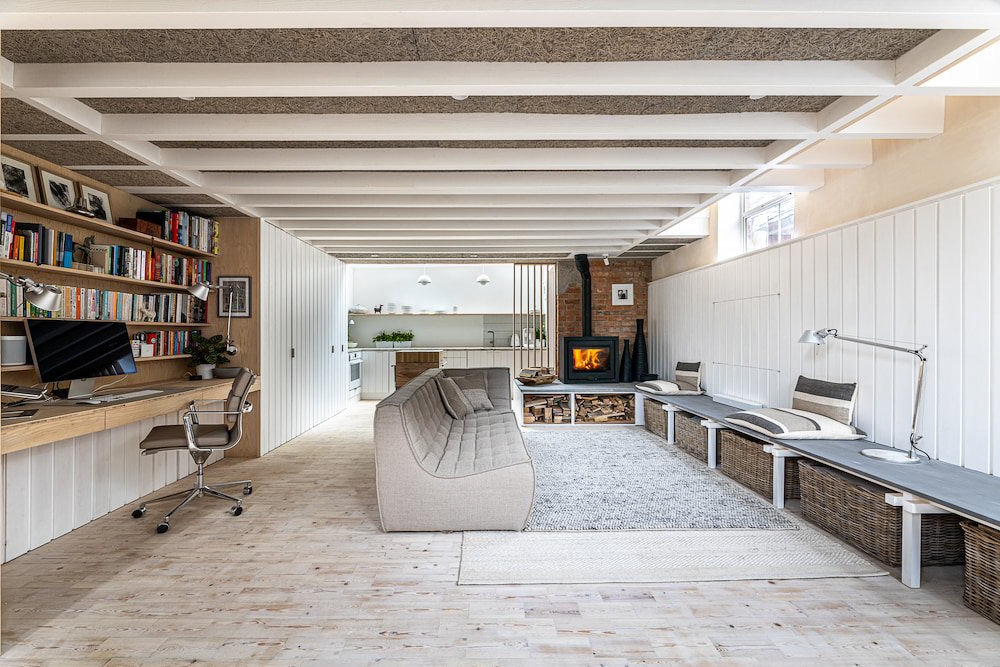a living room with a couch and a desk